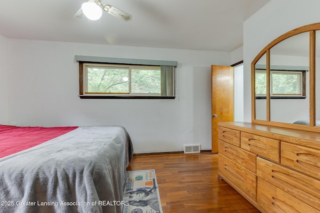 15157 Chetwyn Dr, Lansing, MI 48906 - bedroom featuring multiple windows, wood finished floors, and baseboards