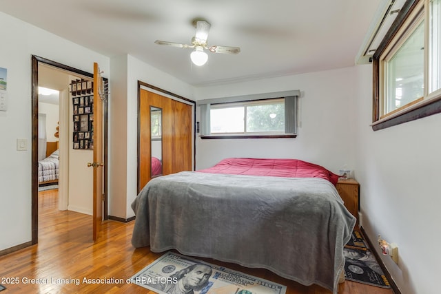 15157 Chetwyn Dr, Lansing, MI 48906 - bedroom featuring wood finished floors, a ceiling fan, a closet, and baseboards