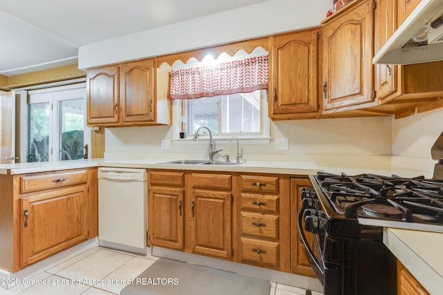 15157 Chetwyn Dr, Lansing, MI 48906 - kitchen with dishwasher, gas stove, a sink, under cabinet range hood, and brown cabinetry