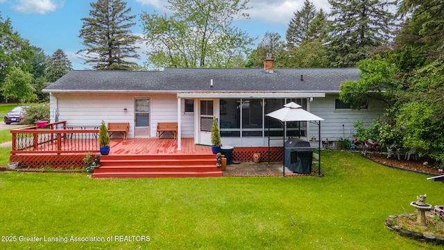 15157 Chetwyn Dr, Lansing, MI 48906 - back of property with a sunroom, a wooden deck, a chimney, and a yard