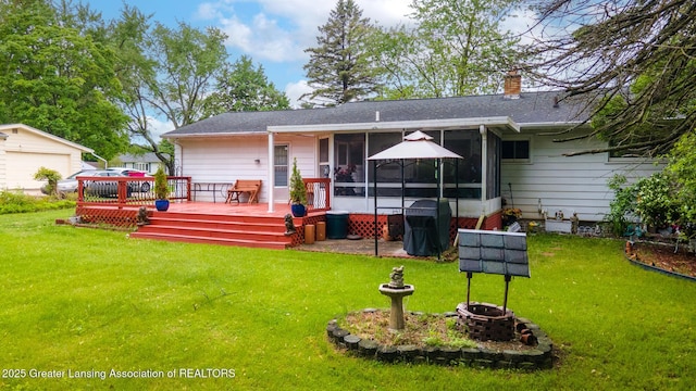 15157 Chetwyn Dr, Lansing, MI 48906 - back of house featuring a sunroom, a deck, a lawn, and a chimney
