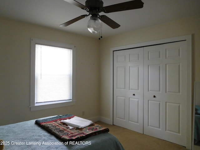 2229 Ives Rd, Leslie, MI 49251 - bedroom with multiple windows, light carpet, a closet, and ceiling fan