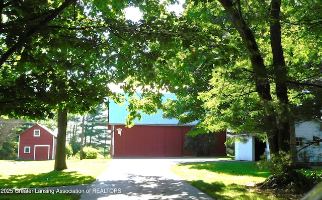 2229 Ives Rd, Leslie, MI 49251 - exterior space with an outdoor structure, a detached garage, and a barn