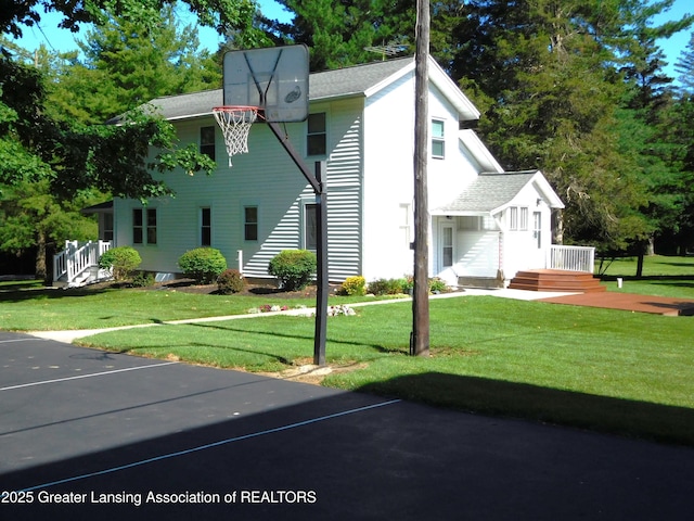 2229 Ives Rd, Leslie, MI 49251 - view of basketball court featuring a lawn