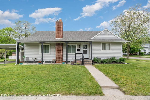 504 Iowa St, Alma, MI 48801 - view of front facade with a front yard, roof with shingles, a chimney, and a carport
