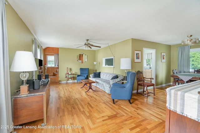 504 Iowa St, Alma, MI 48801 - living area featuring healthy amount of natural light, a ceiling fan, light wood finished floors, and baseboards