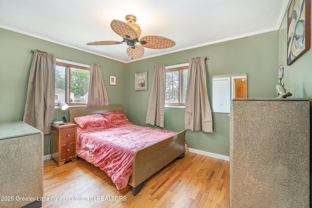 504 Iowa St, Alma, MI 48801 - bedroom with wood-type flooring, crown molding, baseboards, and ceiling fan