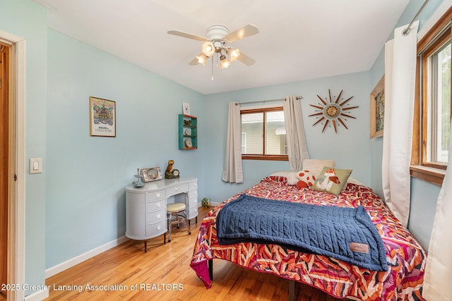 504 Iowa St, Alma, MI 48801 - bedroom with multiple windows, wood finished floors, baseboards, and ceiling fan