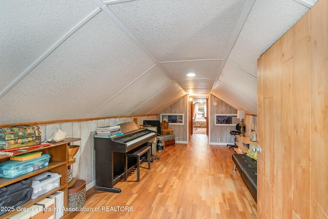 504 Iowa St, Alma, MI 48801 - office area with wood finished floors, a textured ceiling, lofted ceiling, and wooden walls