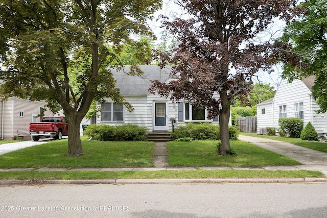 1720 Quentin Ave, Lansing, MI 48910 - view of property hidden behind natural elements with a shingled roof