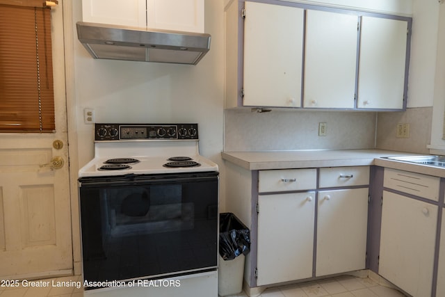 1720 Quentin Ave, Lansing, MI 48910 - kitchen with white electric range oven, under cabinet range hood, light countertops, and white cabinetry