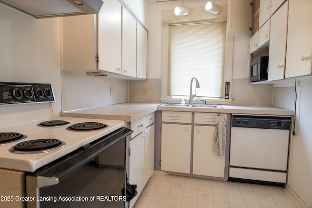 1720 Quentin Ave, Lansing, MI 48910 - kitchen with white dishwasher, electric stove, a sink, black microwave, and light countertops