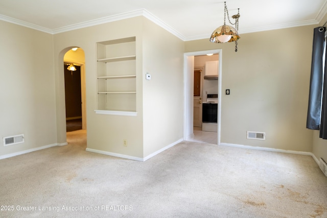 1720 Quentin Ave, Lansing, MI 48910 - carpeted spare room featuring built in features, crown molding, baseboards, and arched walkways