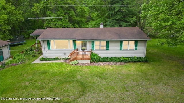 8279 Tyrrell Rd, Laingsburg, MI 48848 - single story home featuring a trampoline, a front yard, a chimney, and a wooded view