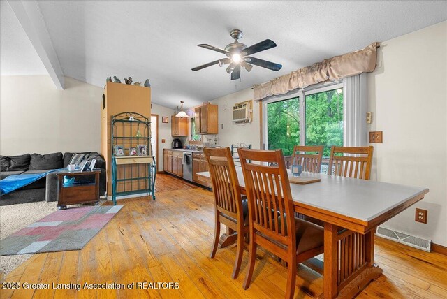 8279 Tyrrell Rd, Laingsburg, MI 48848 - dining area with light wood-type flooring, ceiling fan, a wall unit AC, and lofted ceiling