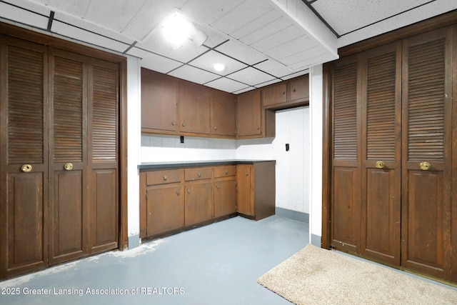 6415 Creyts Rd, Dimondale, MI 48821 - kitchen with concrete floors, a paneled ceiling, and light countertops