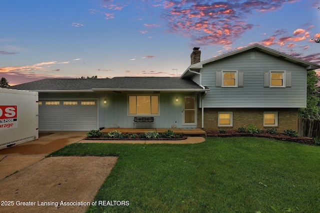 6415 Creyts Rd, Dimondale, MI 48821 - tri-level home featuring driveway, a garage, a chimney, and brick siding