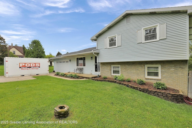 6415 Creyts Rd, Dimondale, MI 48821 - split level home with a front lawn and a garage