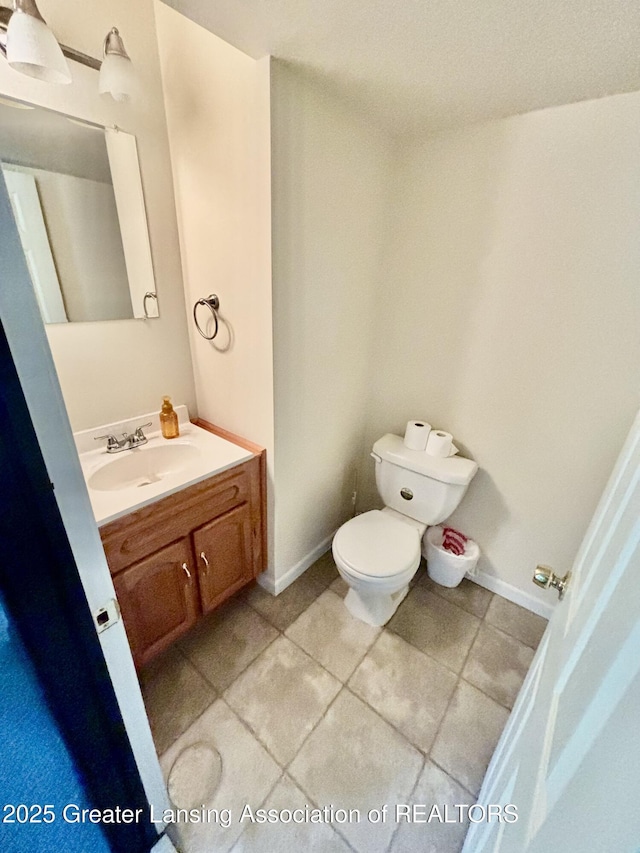 405 N Iris Ln, Laingsburg, MI 48848 - bathroom with toilet, vanity, tile patterned floors, and baseboards