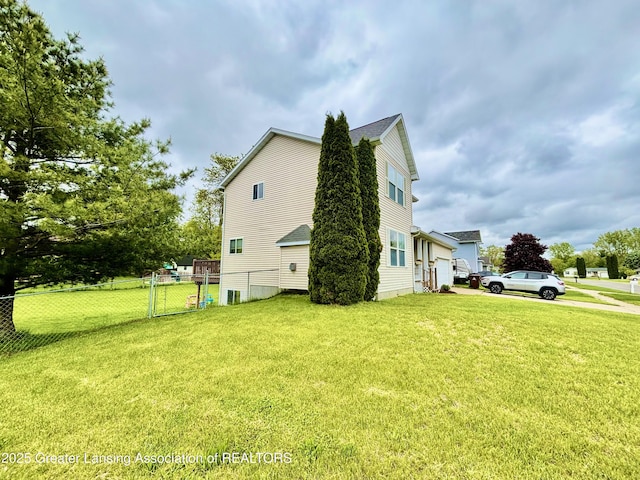 405 N Iris Ln, Laingsburg, MI 48848 - view of side of home featuring an attached garage and a gate