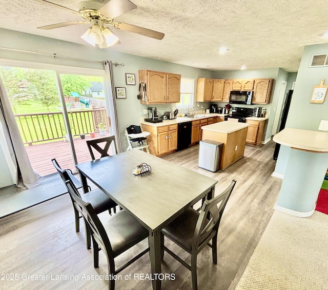 405 N Iris Ln, Laingsburg, MI 48848 - dining area featuring a textured ceiling, light wood-style floors, a ceiling fan, and baseboards