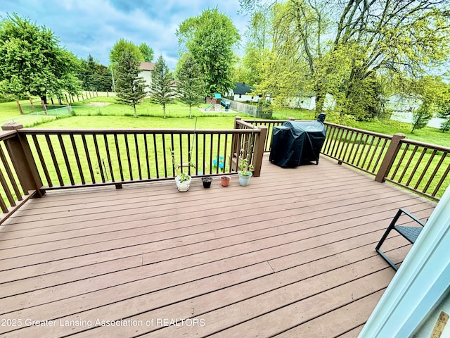 405 N Iris Ln, Laingsburg, MI 48848 - deck featuring a playground, a yard, and a grill