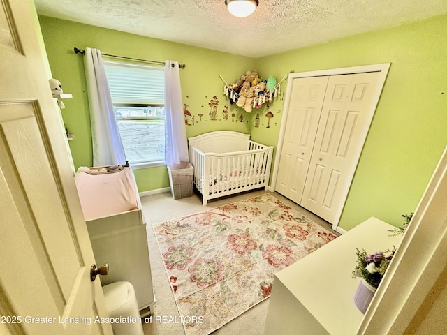 405 N Iris Ln, Laingsburg, MI 48848 - bedroom with a textured ceiling, a closet, baseboards, and carpet floors