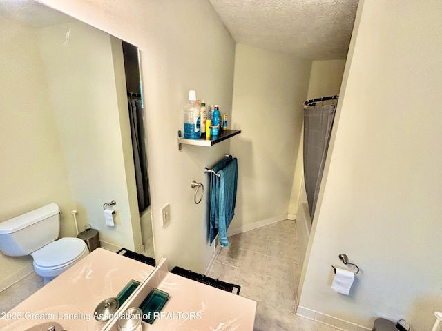 405 N Iris Ln, Laingsburg, MI 48848 - full bathroom featuring vanity, a textured ceiling, toilet, a shower with shower curtain, and tile patterned floors