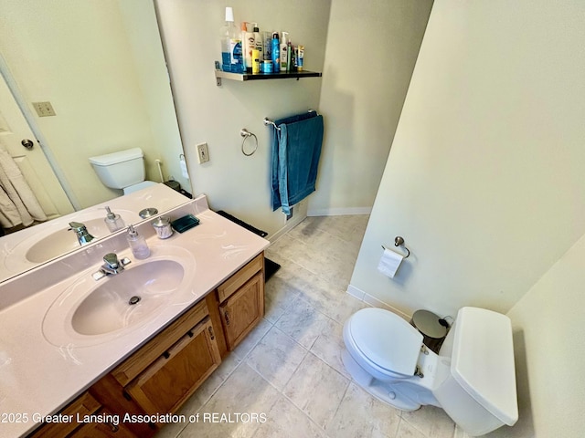405 N Iris Ln, Laingsburg, MI 48848 - bathroom featuring toilet, vanity, and tile patterned flooring