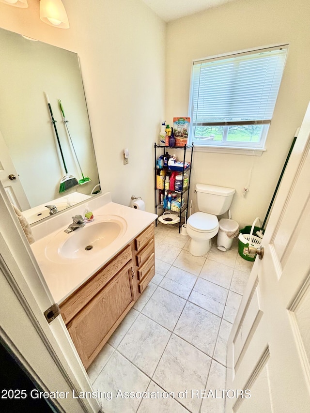 405 N Iris Ln, Laingsburg, MI 48848 - bathroom featuring toilet, vanity, and tile patterned floors