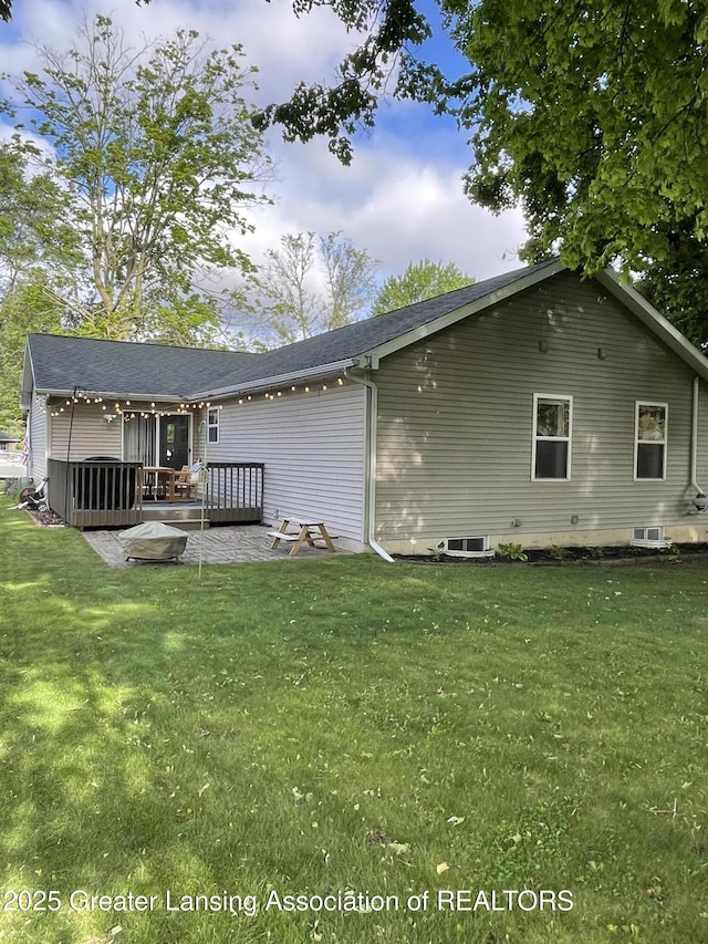 623 Horatio St, Charlotte, MI 48813 - rear view of house with a lawn and a wooden deck
