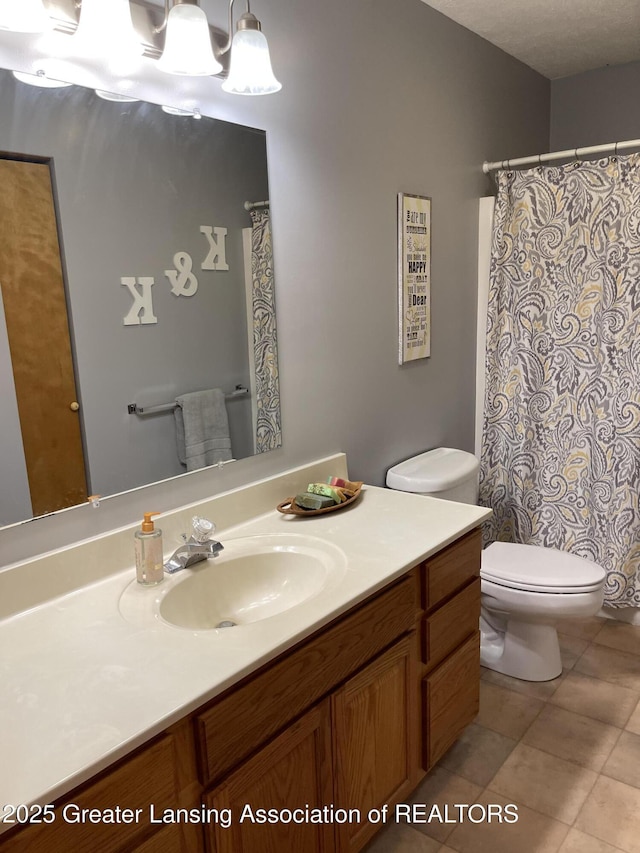 623 Horatio St, Charlotte, MI 48813 - full bath featuring vanity, toilet, and tile patterned floors