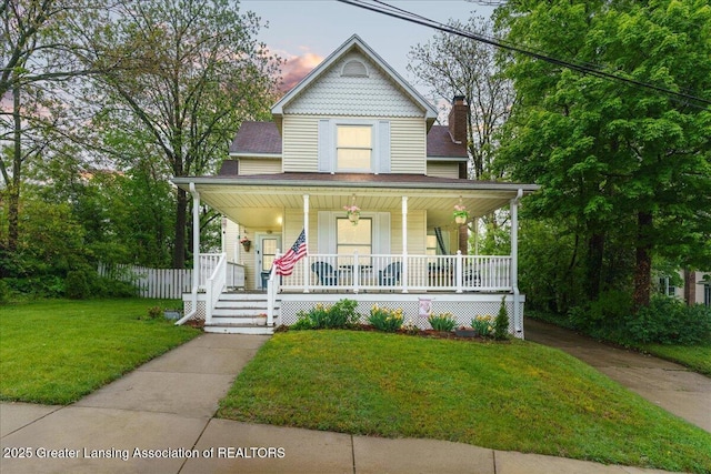 218 Russell St, Grand Ledge, MI 48837 - victorian-style house featuring a porch and a front lawn