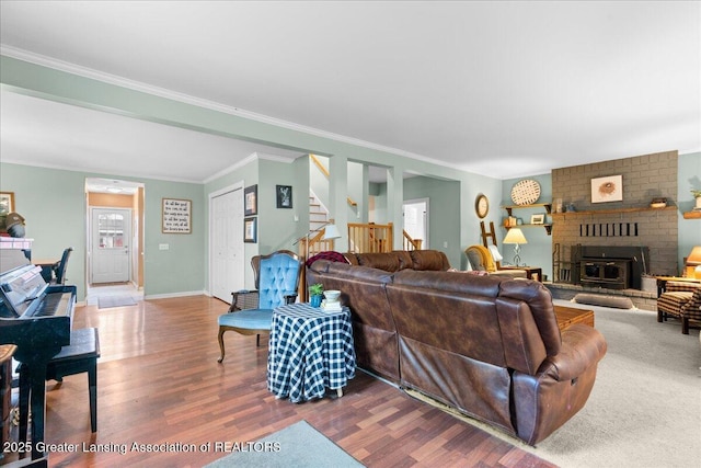 218 Russell St, Grand Ledge, MI 48837 - living area featuring wood finished floors, stairs, crown molding, a fireplace, and baseboards