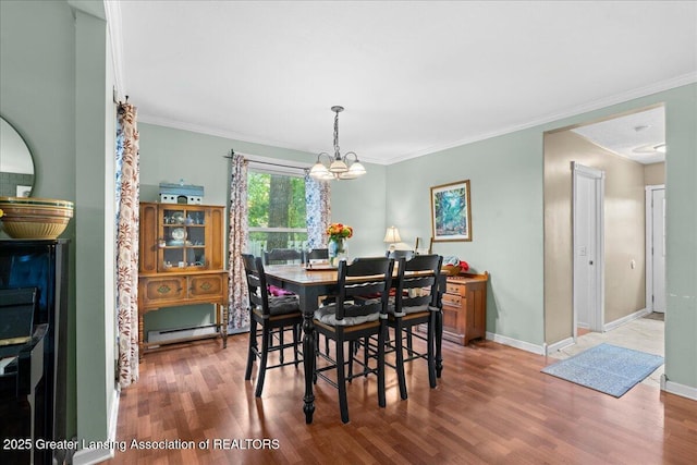 218 Russell St, Grand Ledge, MI 48837 - dining room with a chandelier, wood finished floors, baseboards, and ornamental molding