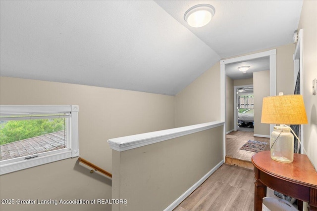 218 Russell St, Grand Ledge, MI 48837 - hall with an upstairs landing, wood finished floors, lofted ceiling, and baseboards