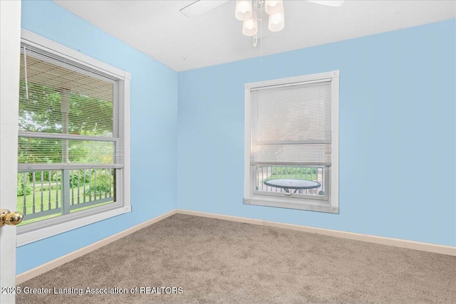 218 Russell St, Grand Ledge, MI 48837 - empty room featuring carpet floors, baseboards, and ceiling fan