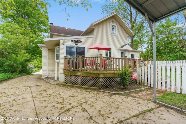 218 Russell St, Grand Ledge, MI 48837 - back of property featuring a chimney and a wooden deck