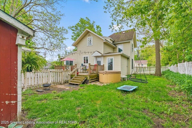 218 Russell St, Grand Ledge, MI 48837 - back of property featuring a hot tub and a deck