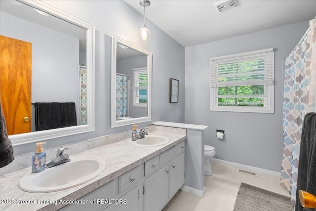 420 John R St, East Lansing, MI 48823 - bathroom featuring double vanity, toilet, baseboards, and a shower with curtain
