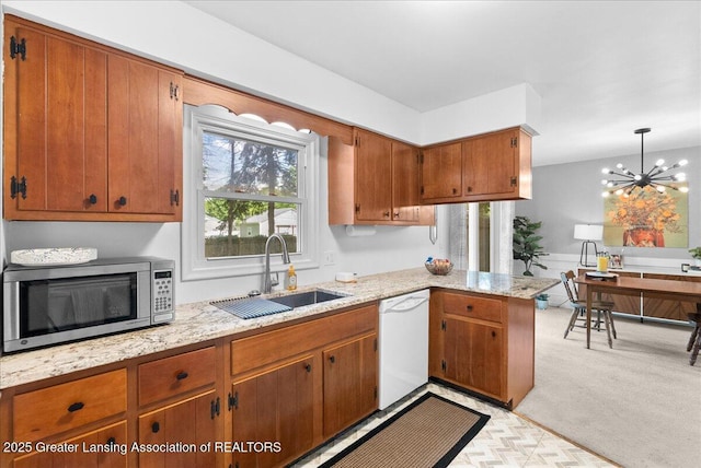 420 John R St, East Lansing, MI 48823 - kitchen with stainless steel microwave, a sink, white dishwasher, brown cabinetry, and a peninsula