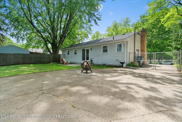 420 John R St, East Lansing, MI 48823 - back of house with a chimney, a patio area, a fire pit, and a gate