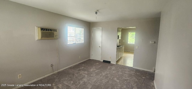 6622 Aurelius Rd, Lansing, MI 48911 - unfurnished room with a wall unit AC, carpet floors, and baseboards