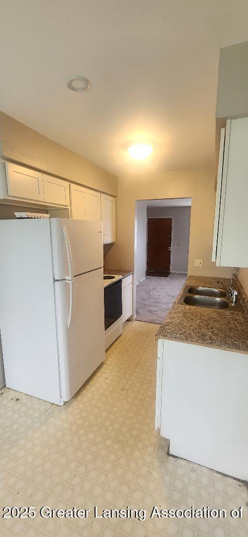 6622 Aurelius Rd, Lansing, MI 48911 - kitchen featuring white appliances, a sink, white cabinetry, and light flooring