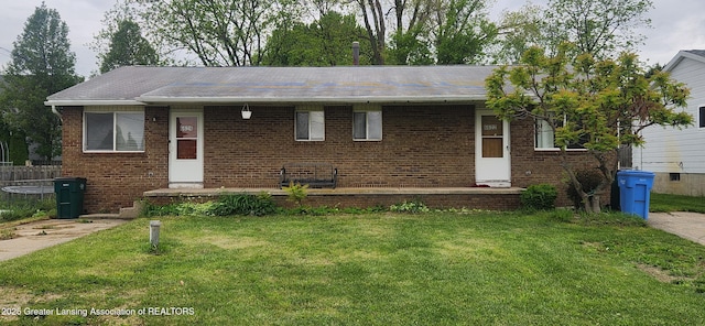 6622 Aurelius Rd, Lansing, MI 48911 - ranch-style home featuring a front yard and brick siding