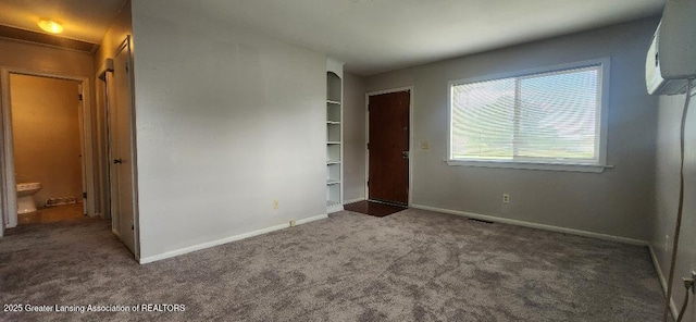 6622 Aurelius Rd, Lansing, MI 48911 - unfurnished bedroom featuring carpet, baseboards, and a wall mounted air conditioner