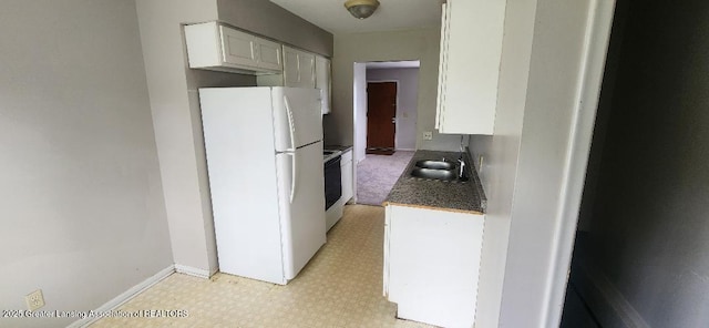 6622 Aurelius Rd, Lansing, MI 48911 - kitchen featuring freestanding refrigerator, a sink, light flooring, white cabinets, and baseboards