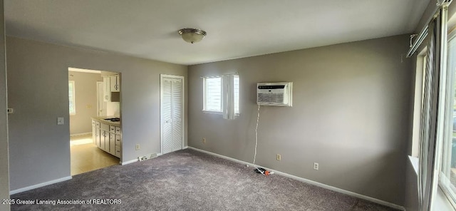 6622 Aurelius Rd, Lansing, MI 48911 - unfurnished bedroom featuring a wall mounted air conditioner, carpet floors, baseboards, and ensuite bath