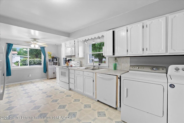 407 Kearney St, Portland, MI 48875 - laundry area with washing machine and clothes dryer, plenty of natural light, a ceiling fan, and baseboards