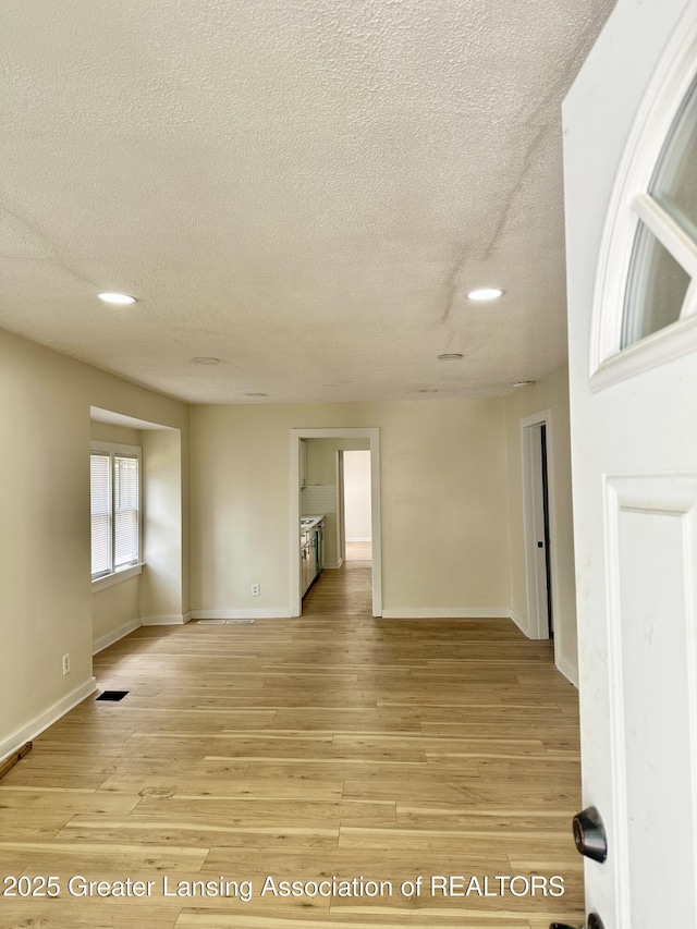 218 S Hayford Ave, Lansing, MI 48912 - unfurnished room featuring a textured ceiling, light wood finished floors, baseboards, and recessed lighting